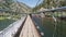 Walking across a pedestrian bridge over the truckee river