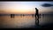 Walking alone at the kuta beach with beautiful sunset behind, Bali.