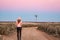 Walking along dirt road of vast open spaces of outback