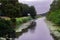 Walking along the royal Military Canal in Romney Marsh on a cloudy summer day