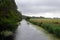 Walking along the royal Military Canal in Romney Marsh on a cloudy summer day