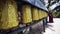 Walking along wall rotating prayer wheels