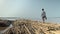 Walking on bamboo poles tied in bundles and stored in water of the Mekong river