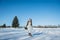 Walking bride on a snowy road. beautiful brunette in a short wedding dress, rustic style, with the pine-tree wedding bouquet, and