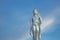 Walking Buddha image silver on a beautiful sky.