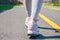 Walking. Close-up of women`s running shoes on a paved trail.