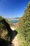 Walking on coastal pathway taking photos of scenic atlantic coast in summer blue sky, hendaye, basque country, france