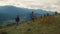 Walking couple hiking mountains. Two travelers going trekking poles in nature.