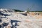 Walking excavator operates near piles row in mining pit