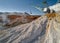 Walking excavator takes chalk with bucket in open quarry