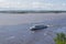 Walking excursion river ship with tourists moves along Amur River. Water level in river is higher than normal. Flooded shores are