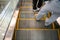 Walking feet wearing flipflop shoe on escalator. Transportation and circulation concept