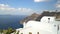 Walking in Fira village of Santorini island on sunny summer vacation day