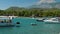 Walking, fishing and inflatable boats are tied up in a beautiful lagoon on the Mediterranean Sea. In the background is a