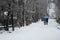 Walking on foot under an umbrella in a mountain village under a heavy snowfall