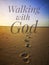 Walking with God with foot print on sandy beach and beautiful sunset view design for Christianity.
