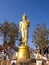 Walking golden buddha statue viewpoint in Nan