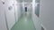 Walking through laboratory corridor. Female worker going chemical lab corridor