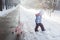 Walking little girl in warm winter clothing among snowdrifts