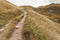 Walking long a mountain path in Valle di Funes into the Italian Dolomites