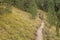 Walking long a mountain path in Valle di Funes into the Italian Dolomites