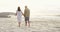 Walking, love and holding hands with couple on beach for romance, bonding and travel at sunset. Relax, holiday trip and