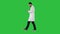 Walking medical professional using smart phone and making attantion gesture on a Green Screen, Chroma Key.