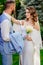 Walking newlyweds in the summer garden. wedding photo shoot in the park