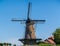 Walking in old Dutch town Zierikzee with old windmill, small houses and streets