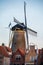 Walking in old Dutch town Zierikzee with old windmill, small houses and streets