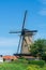 Walking in old Dutch town Zierikzee with old windmill, small houses and streets