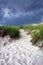 Walking Path over Sand Dune under Stormy Sky