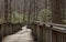 Walking path on wood boardwalk thru woods