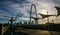 Walking on Pedestrian Bridge near Downtown Dallas Texas as the Sun beams sunrays over the Margaret Hunt Hill Bridge in the shade