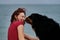 Walking and relaxing with large dog on warm summer morning. Caucasian pretty red haired woman and Bernese Mountain Dog embrace