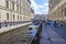 A walking river tram in the canal near the Hermitage. Tourists in the center of St. Petersburg on a sunny summer day