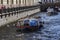 A walking river tram in the canal near the Hermitage. Tourists in the center of St. Petersburg on a sunny summer day