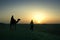 A walking in the Sahara desert, in the sunset light