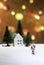 Walking Santa Claus on ice far from house and tree isolated from Christmas light background