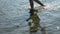 Walking in Shoal. Top view of barefoot man vacationer walking along the beach and sea waves washing his feet.