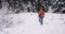 Walking through the snowy field young tourist traveling alone full equipped he wants to exploring the snowy forest