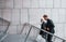 Walking on the stairs. Young guy with senior man in elegant clothes is outdoors together. Conception of business