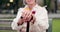 Walking stick, hands and senior woman closeup on a park bench with person with disability. Mobility support, wellness