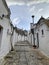 Walking streets of trulli town Alberobello, Italy