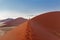 Walking on sunrise dunes in Namibia