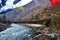 walking suspension bridge over the river with colorful prayer flags in Bhutan