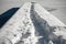 Walking trace on a snowy footbridge on a frozen lake Jasna, Kranjska Gora, Slovenia