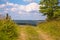 Walking trail on a Hill in a Green Summer Landscape