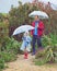 walking, umbrella and nature with a father and child outdoor for family fun, happiness and quality time. Man and boy kid