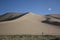 Walking between the Vast Sand Dunes and Vegetation, Khongor region, Gobi Desert.